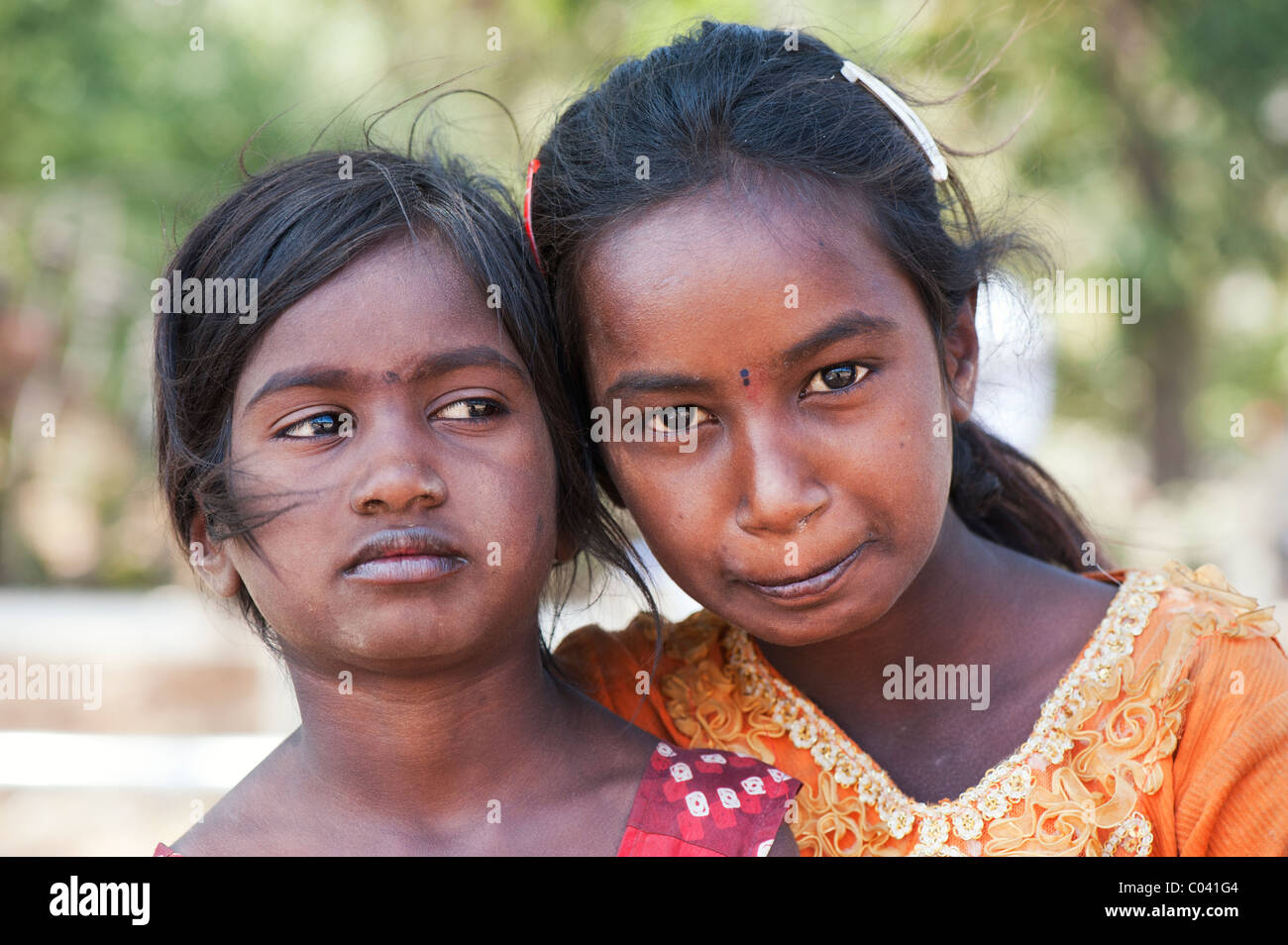 Happy young poor lower caste Indian street girls. Sisters. Andhra Pradesh, India Stock Photo