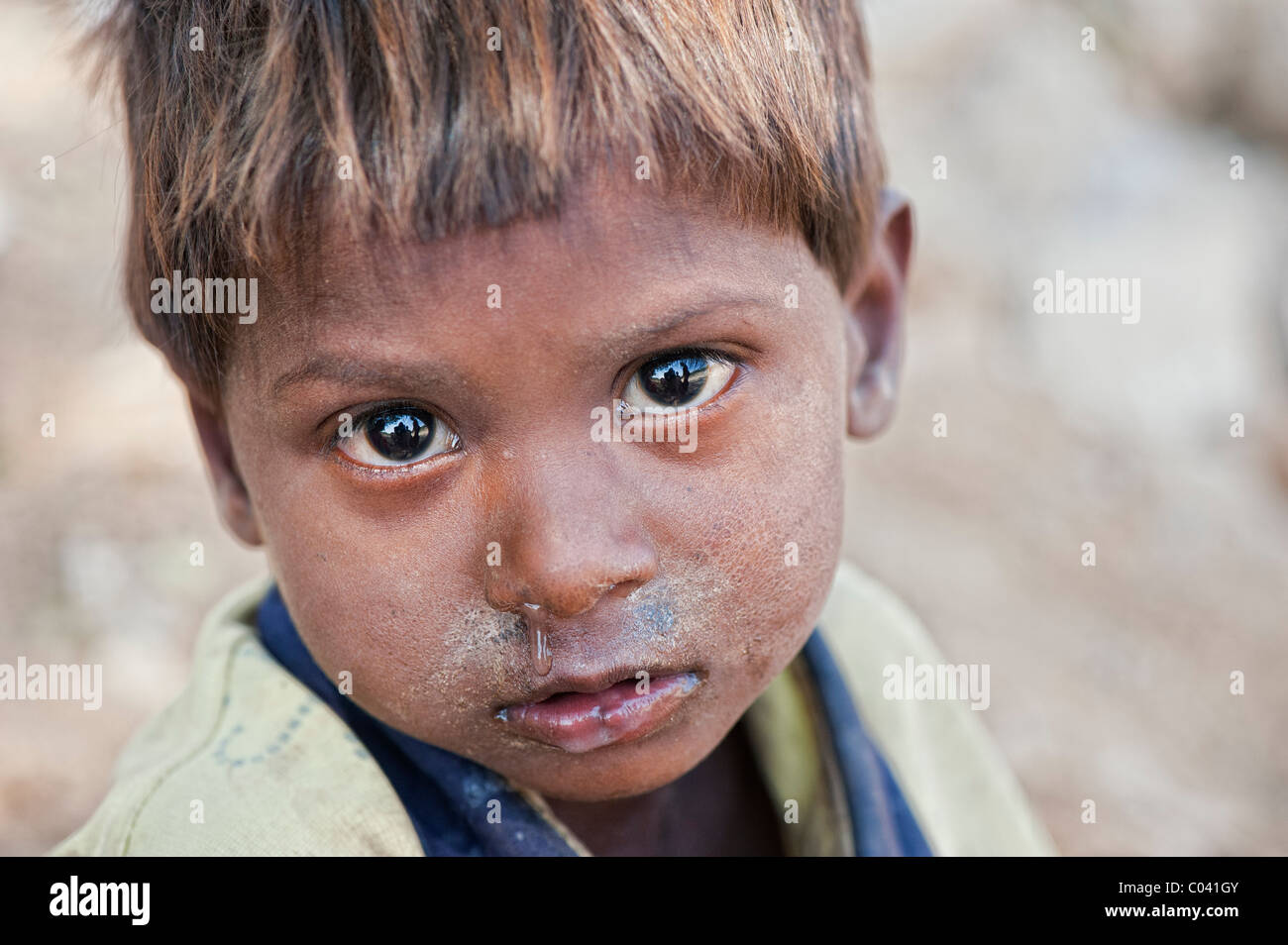 Young poor lower caste Indian street infant boy staring Stock Photo