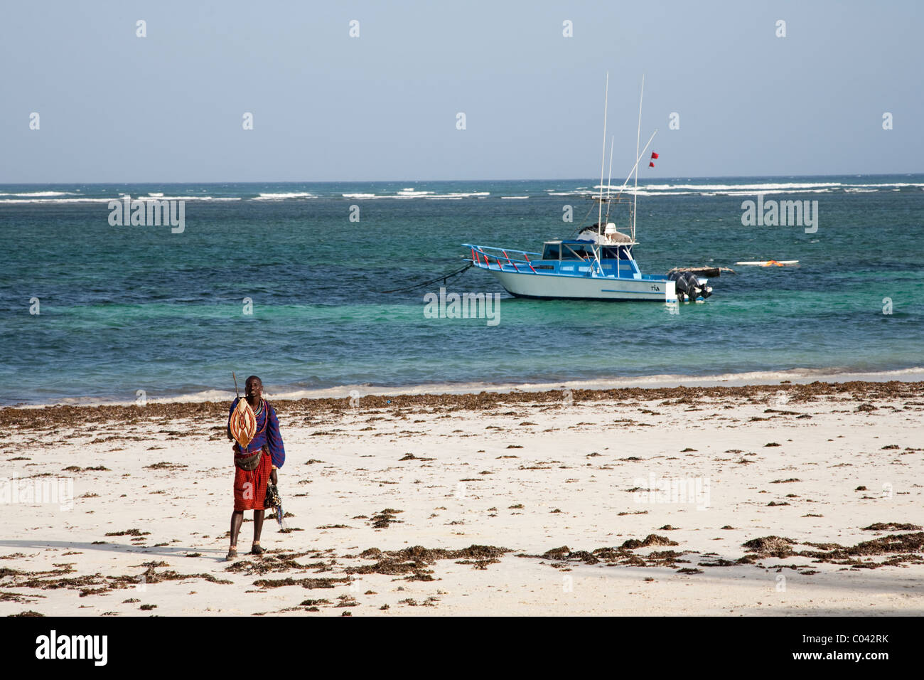 Masai trader on Diani beach waiting for tourists, Kenya Stock Photo