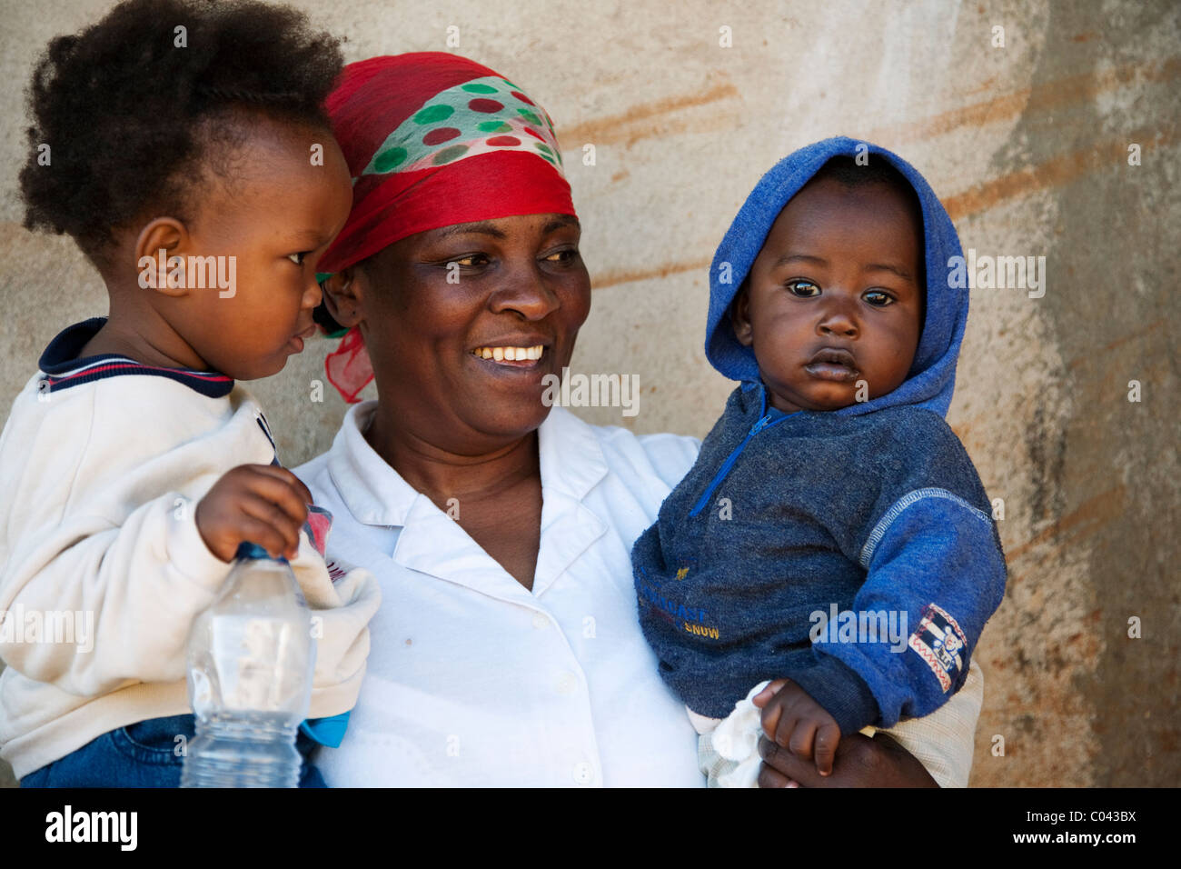 Orphanage mother with two orphans at Shalom Orphanage Centre, Karatu, Tanzania, Africa Stock Photo