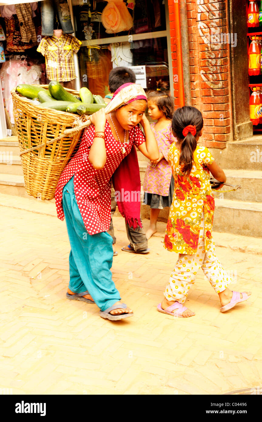 nepalese girl carrying papaya in basket , peoples lives ( the nepalis