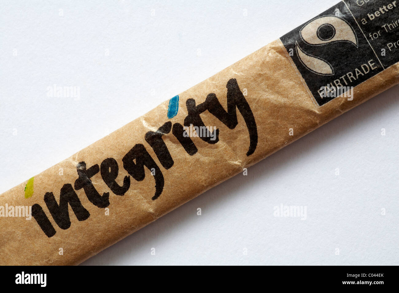 Integrity - sachet of Fairtrade sugar set on white background - Fairtrade logo symbol Fair Trade Stock Photo