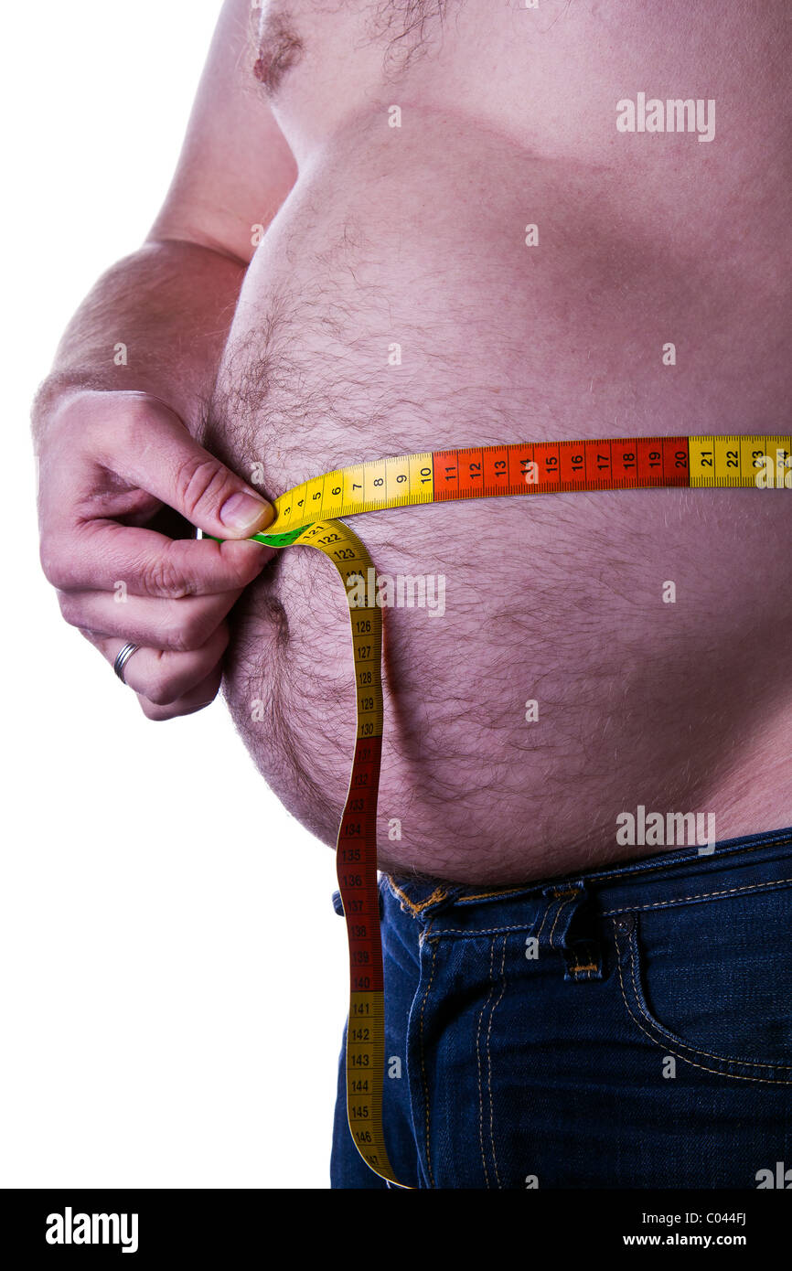 fat man holding a measurement tape around his belly Stock Photo