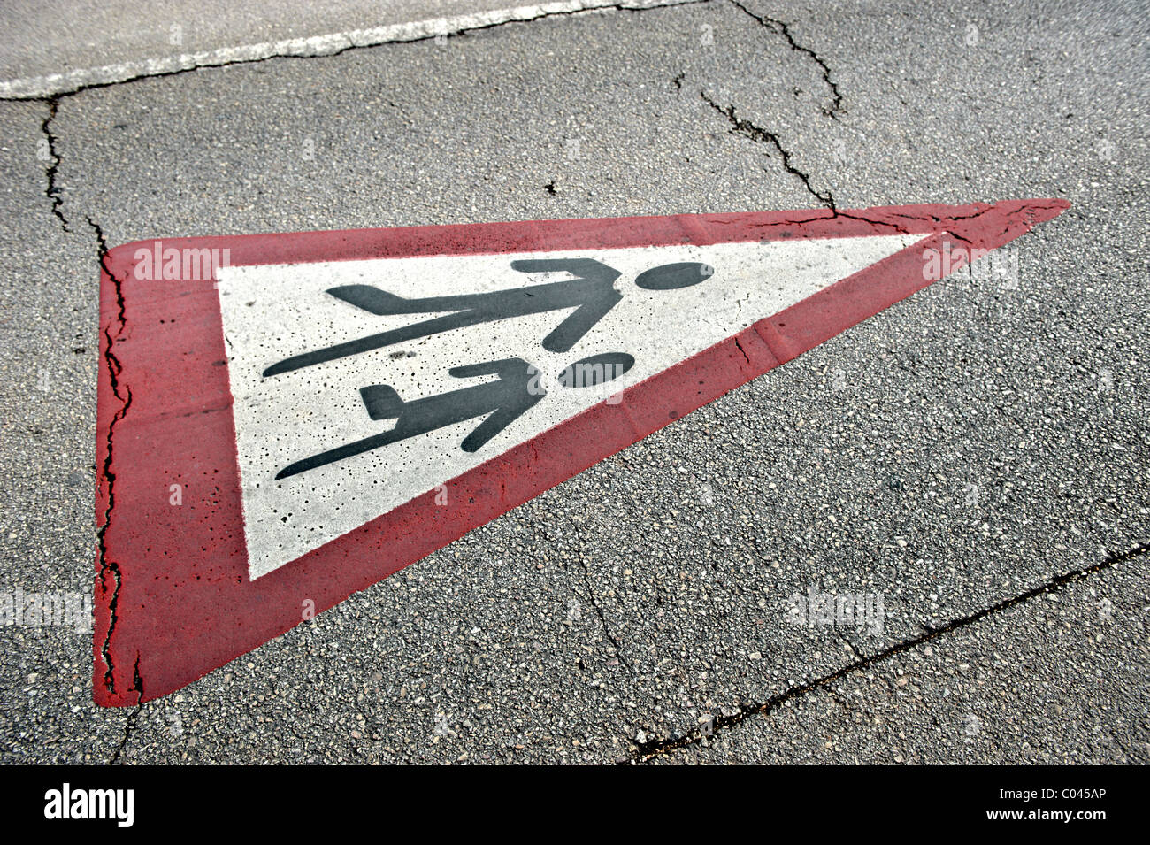 Traffic sign for school children crossing painted on a road pavement Stock Photo