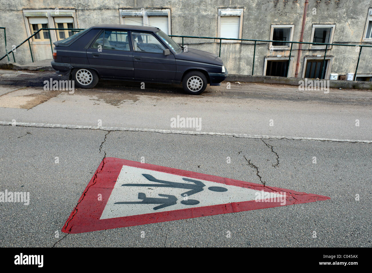 Traffic sign for school children crossing painted on a road pavement Stock Photo