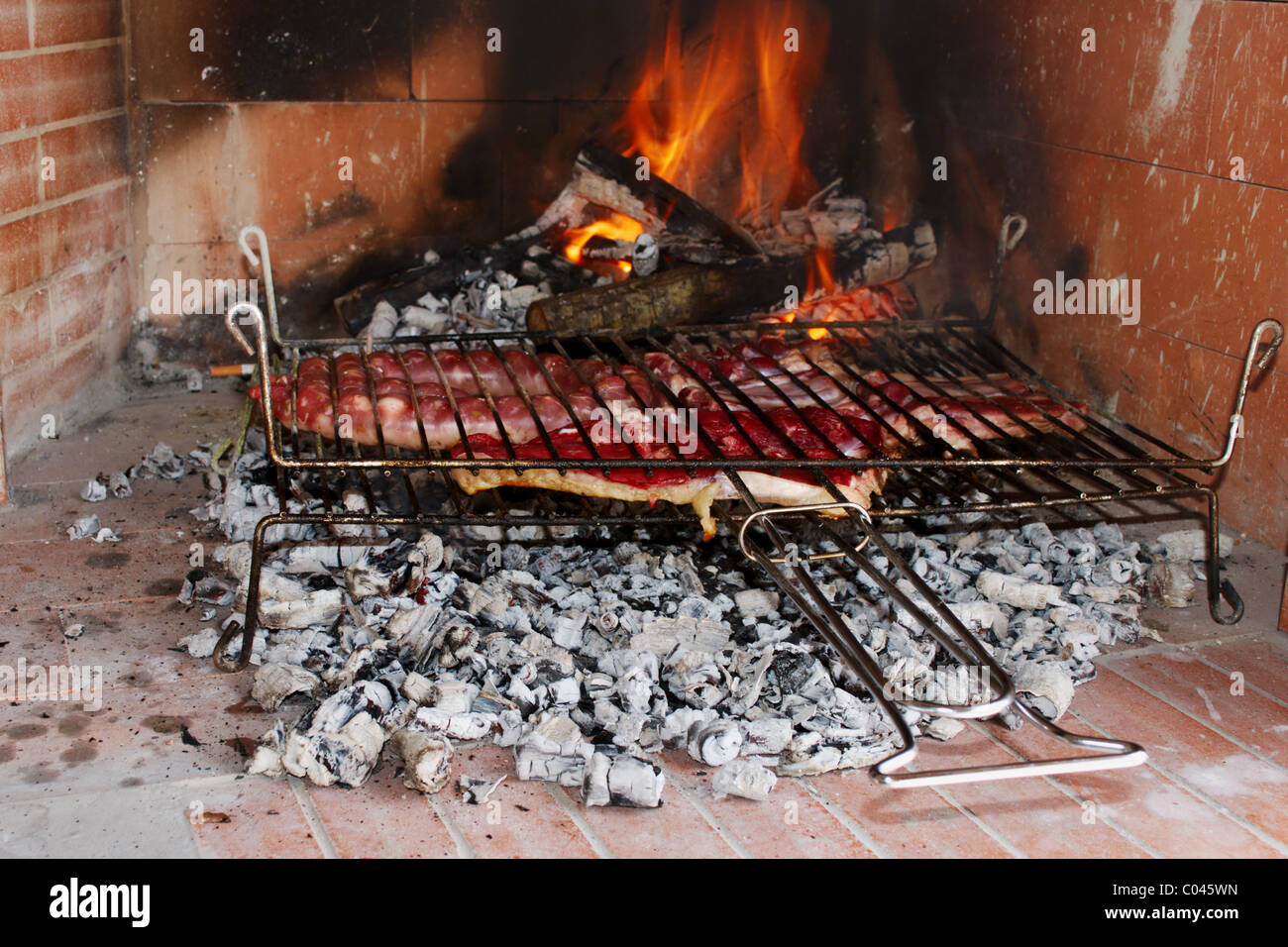 Raw meat just put on the barbecue to cook Stock Photo