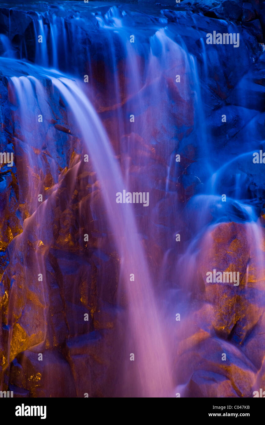 An illuminated waterfall with enhanced coloration Stock Photo