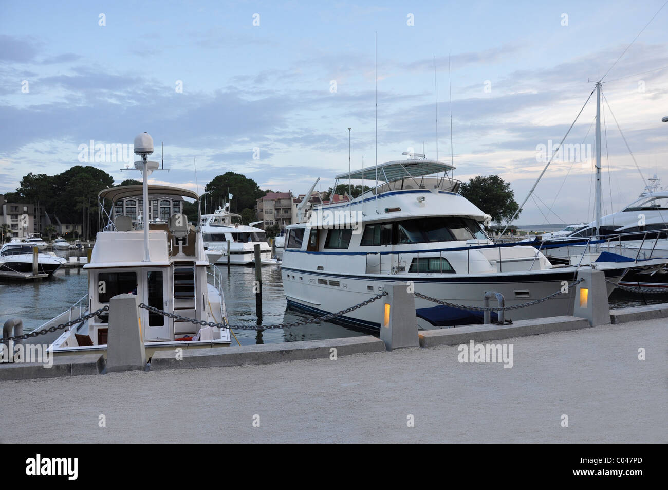 Boats docked in Harbour Town marina at dusk.  The marina is located on Hilton Head Island in South Carolina. Stock Photo