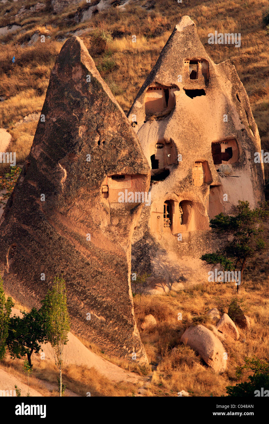 Two conical rocks used as rock cut 'cavehouses' and dovecotes in the 'backside' of Uchisar town, Nevsehir, Cappadocia Stock Photo