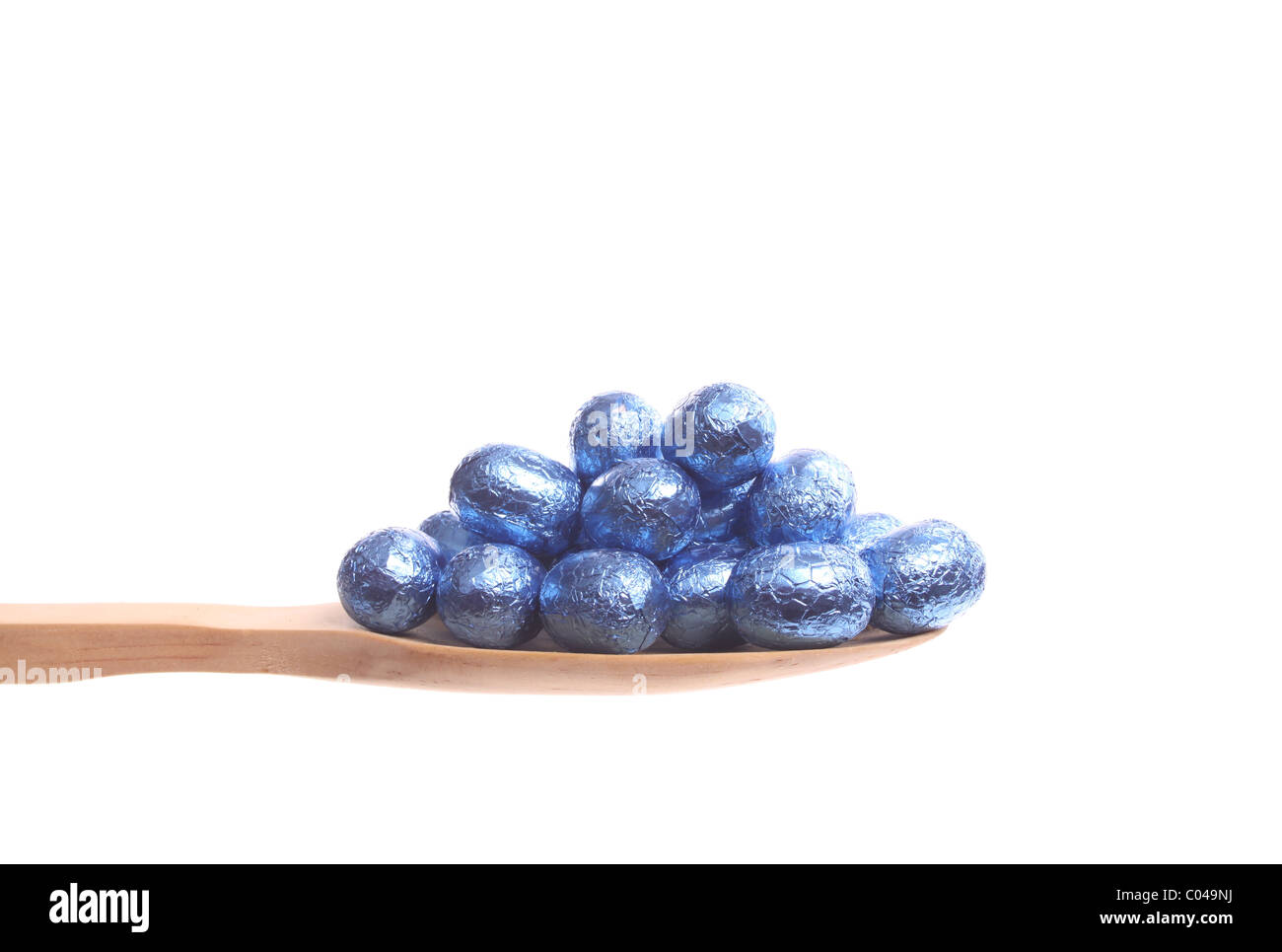 Easter Eggs Simply Offered On A Wooden Spoon Isolated On A White 