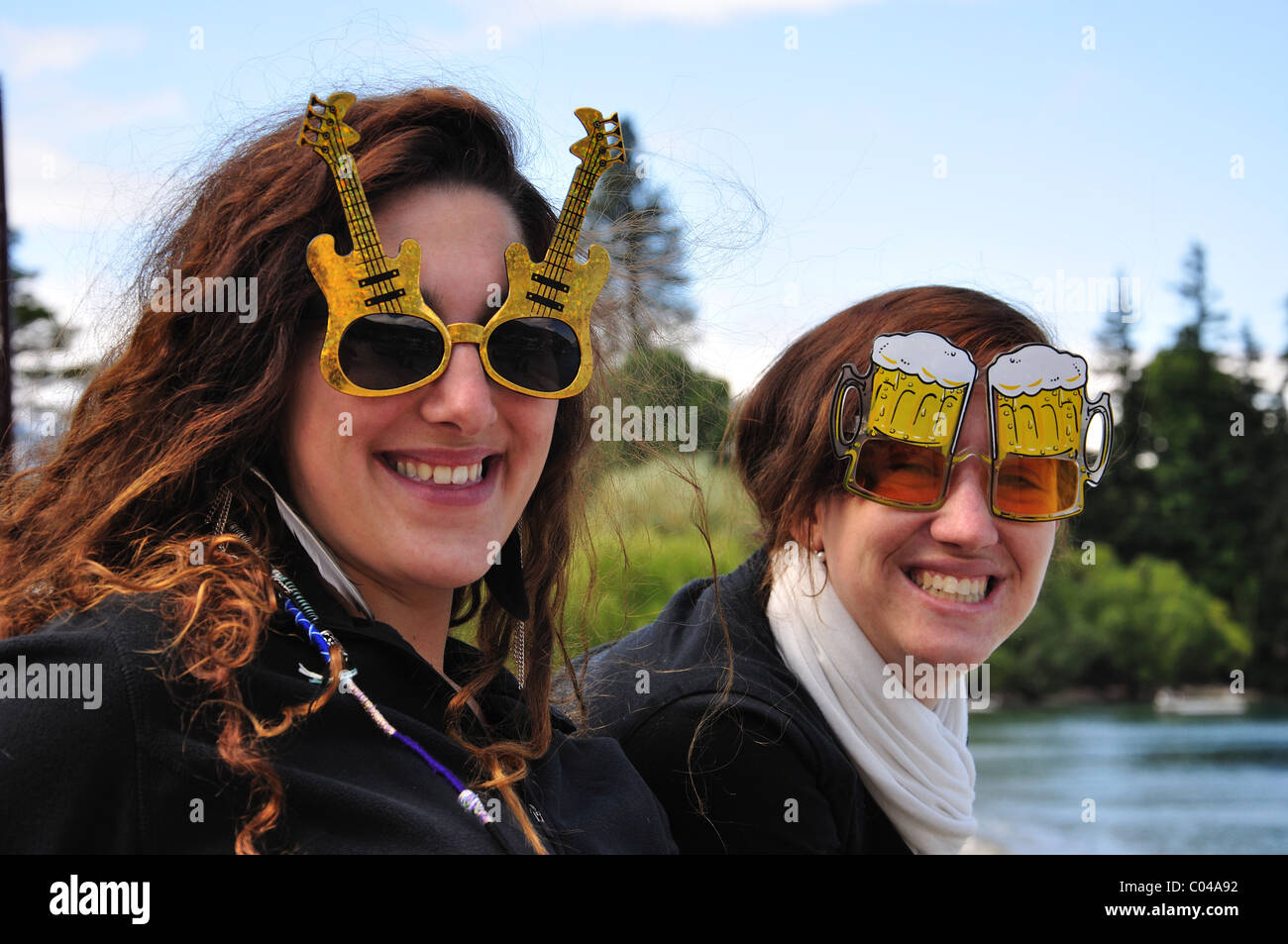 Young tourist women wearing fun sunglasses, Queenstown, Otago Region