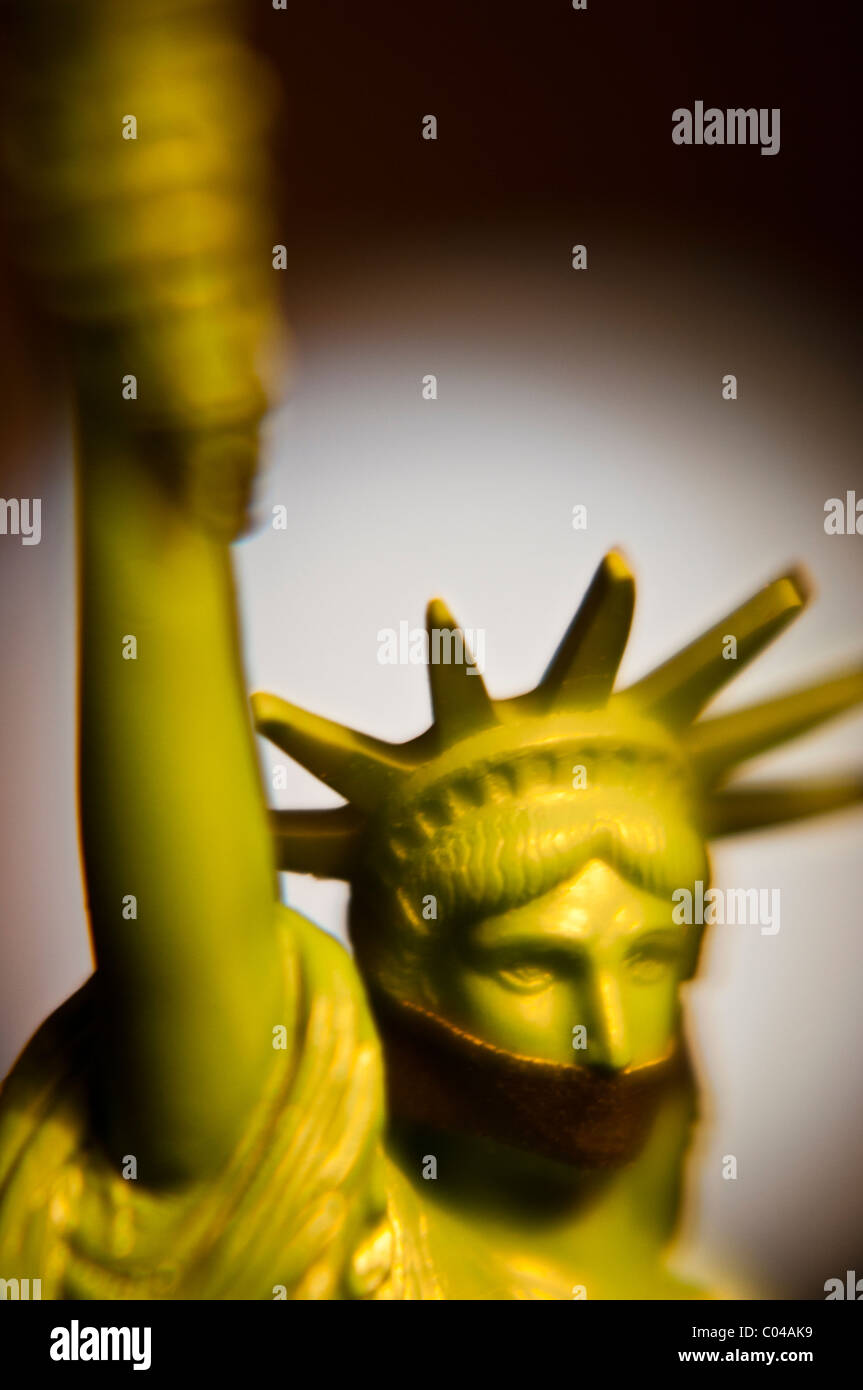 Statue of Liberty figurine with mouth covered Stock Photo Alamy