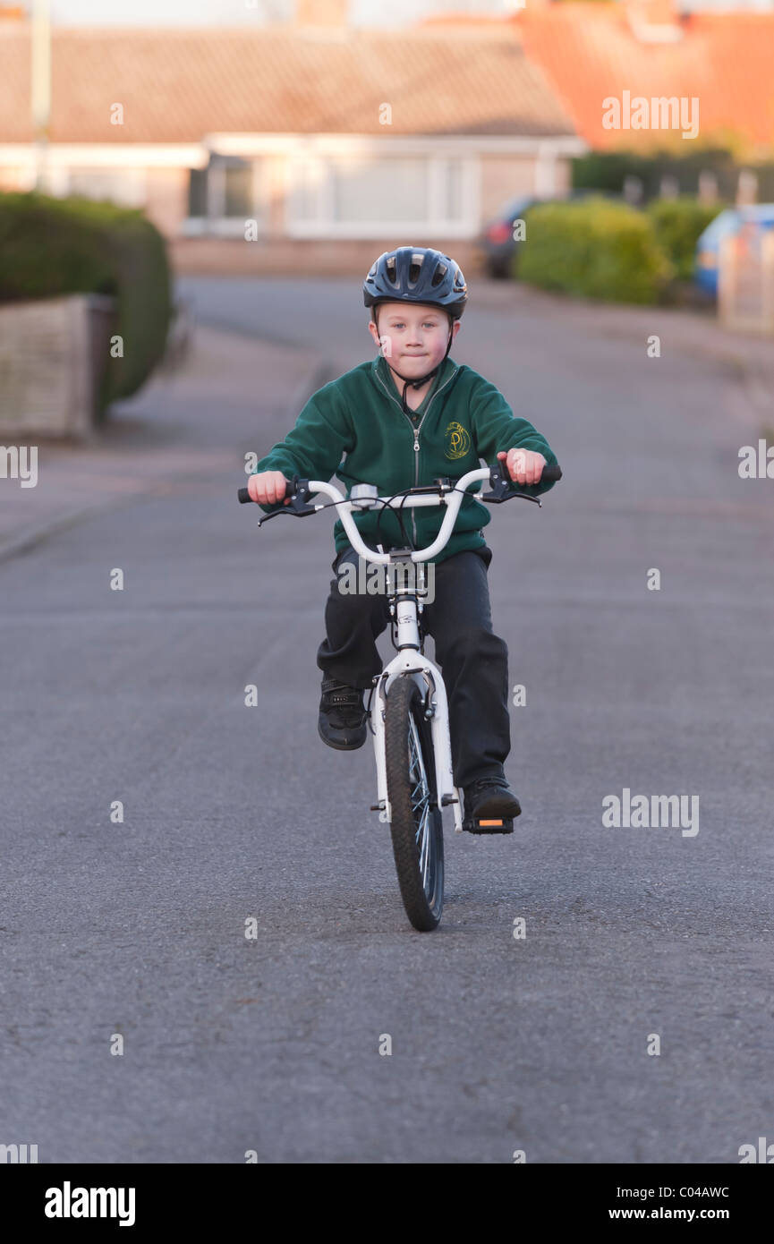 A MODEL RELEASED seven year old boy riding his BMX bike in the Uk Stock