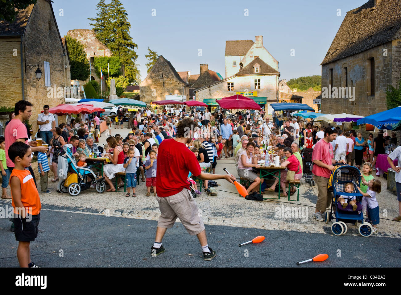 Juggler at village fete traditional festival in St Genies in the Perigord region, France Stock Photo