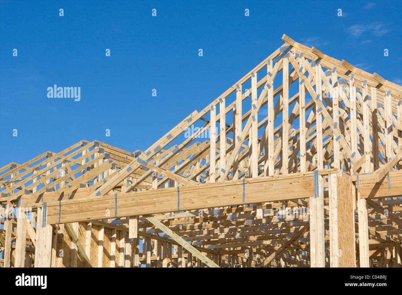 Frame construction of a truss roof with hurricane tie down clips for a house Stock Photo Alamy