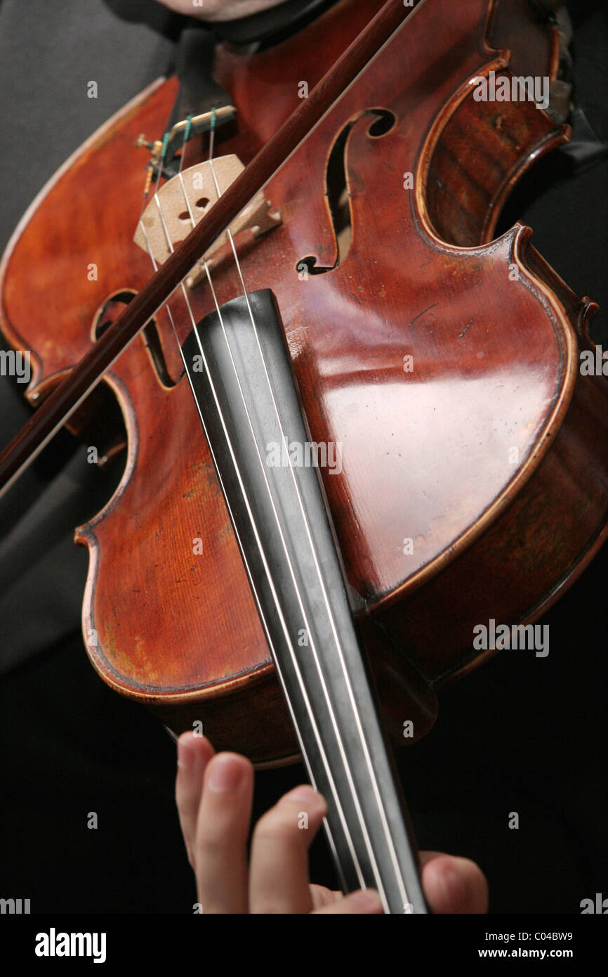 Close up of an old violin being played. Stock Photo