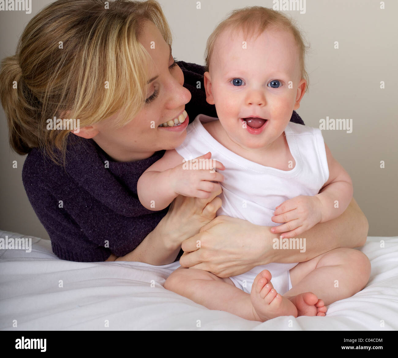 Mother and child smiling playing Stock Photo - Alamy