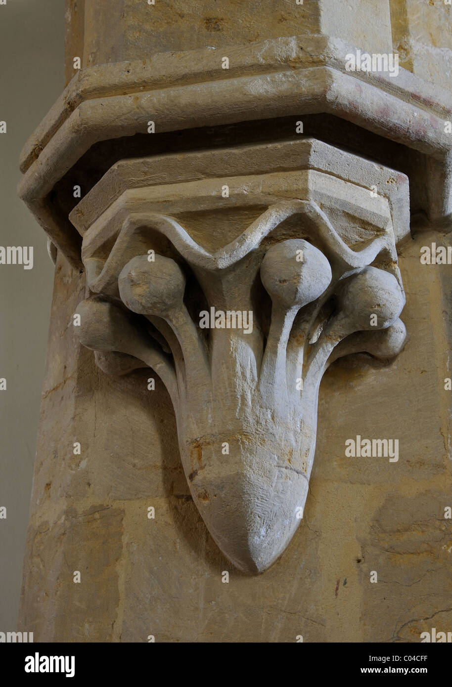 Carved stone capital in St. Barnabas and St. Nicholas Church, Burmington, Warwickshire, England, UK Stock Photo