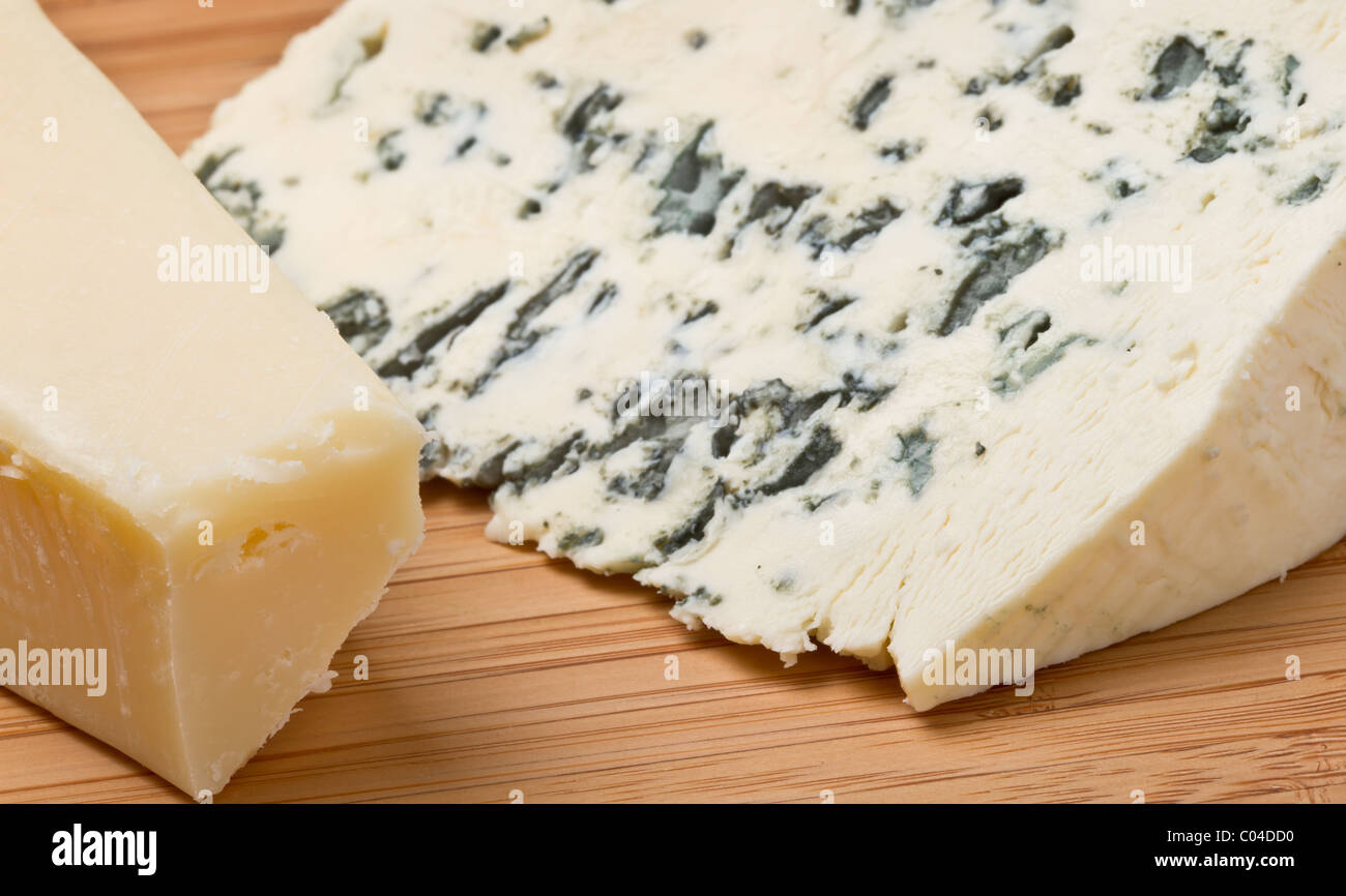 Cheese contrast of Hard parmesan cheese and Soft blue cheese. Stock Photo