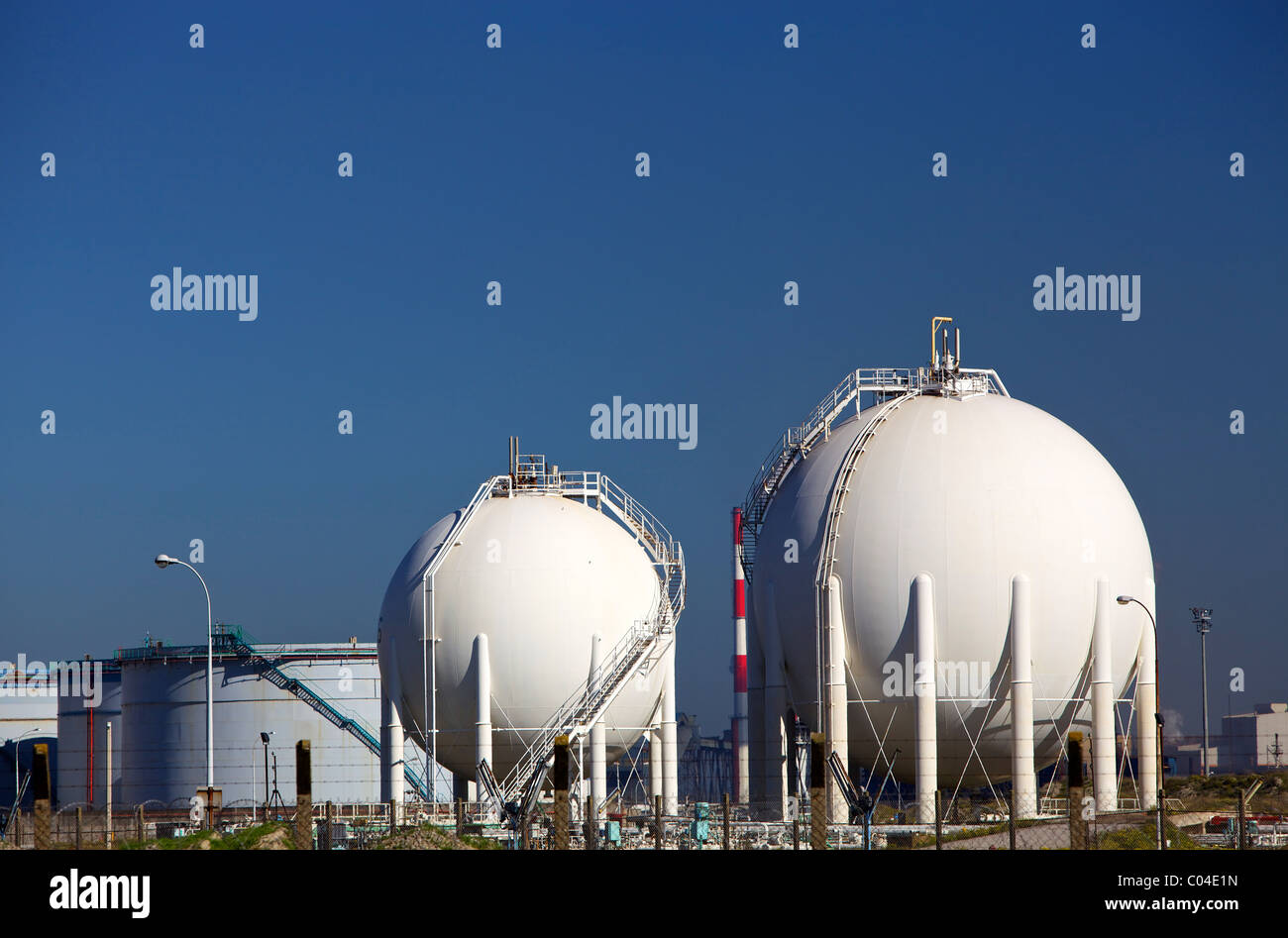 White chemical storage tanks at a petrochemicals manufacturing plant Stock Photo