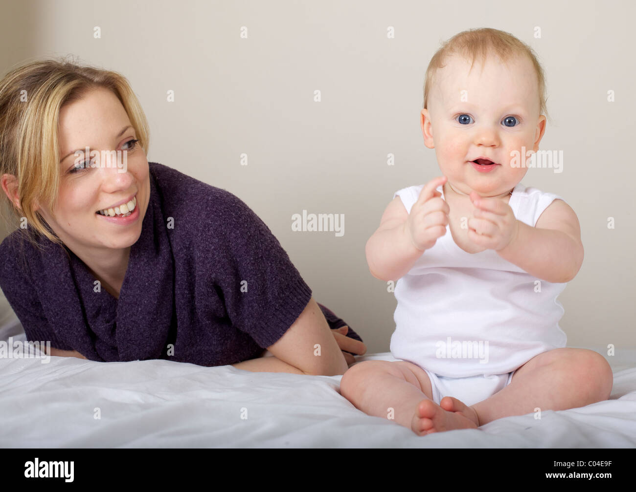 Mother and child smiling playing Stock Photo - Alamy