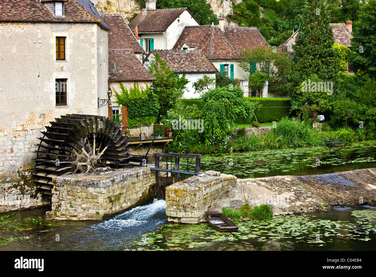Traditional French houses, water wheel and millrace at Angles Sur L'Anglin medieval village, Vienne, near Poitiers, France Stock Photo