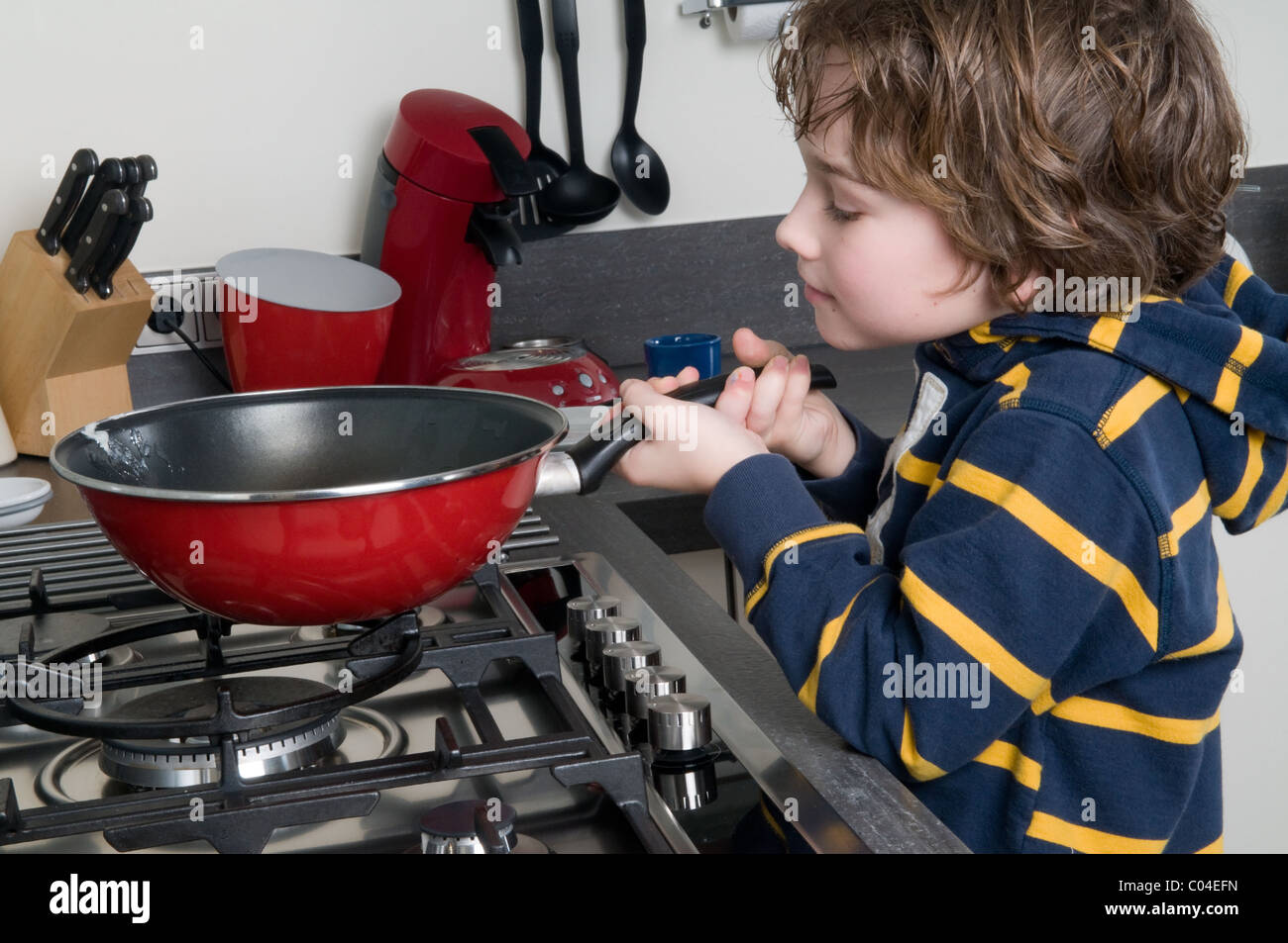 Young boy learning to cook in a modern kitchen Stock Photo - Alamy