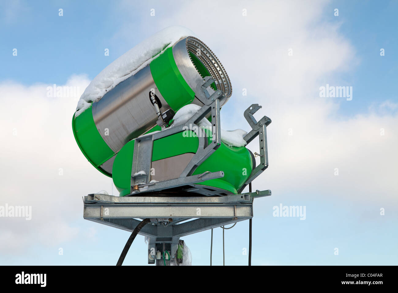 green snow blower against blue sky Stock Photo Alamy