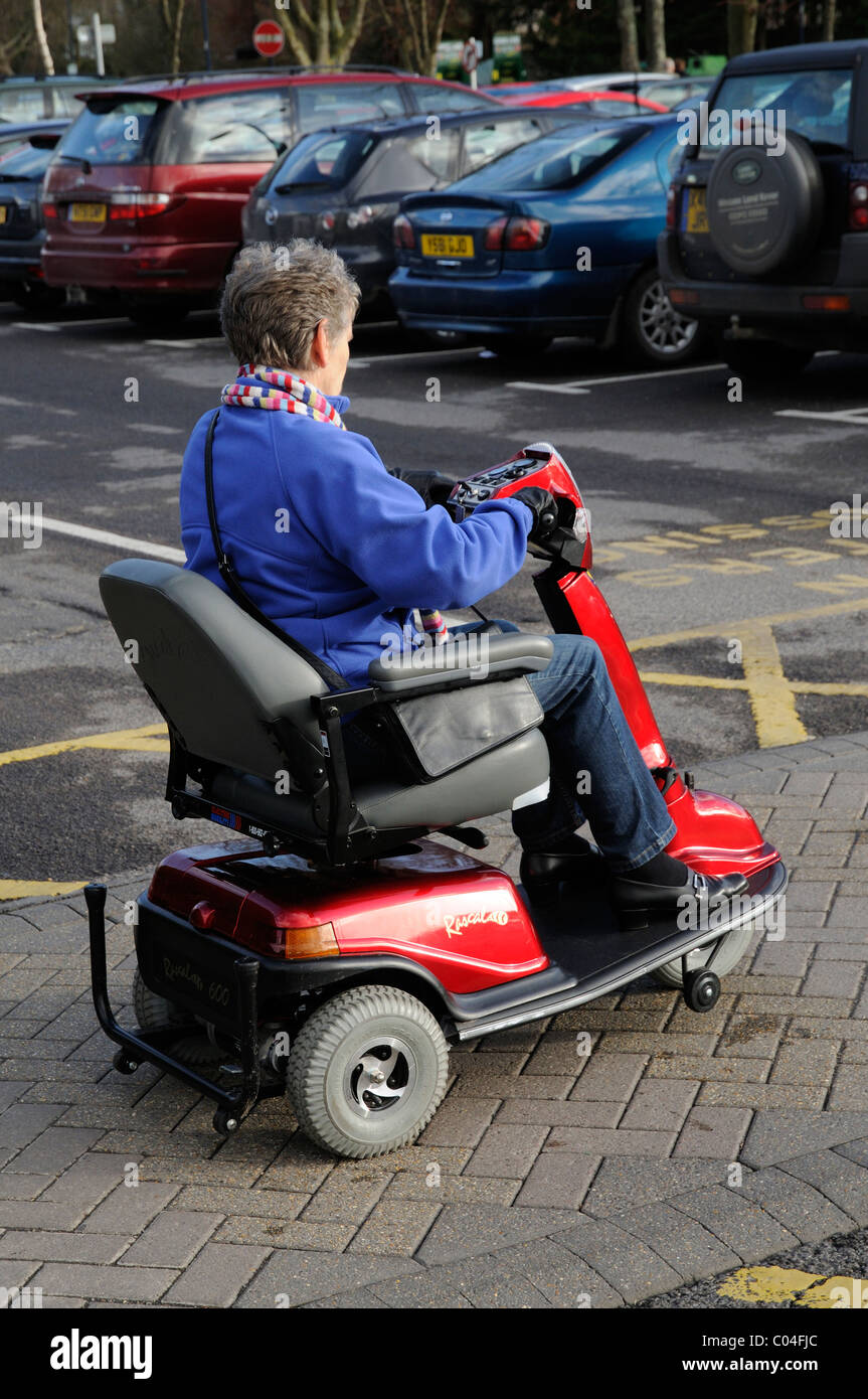 Mobility scooter user riding a three wheel battery powered machine