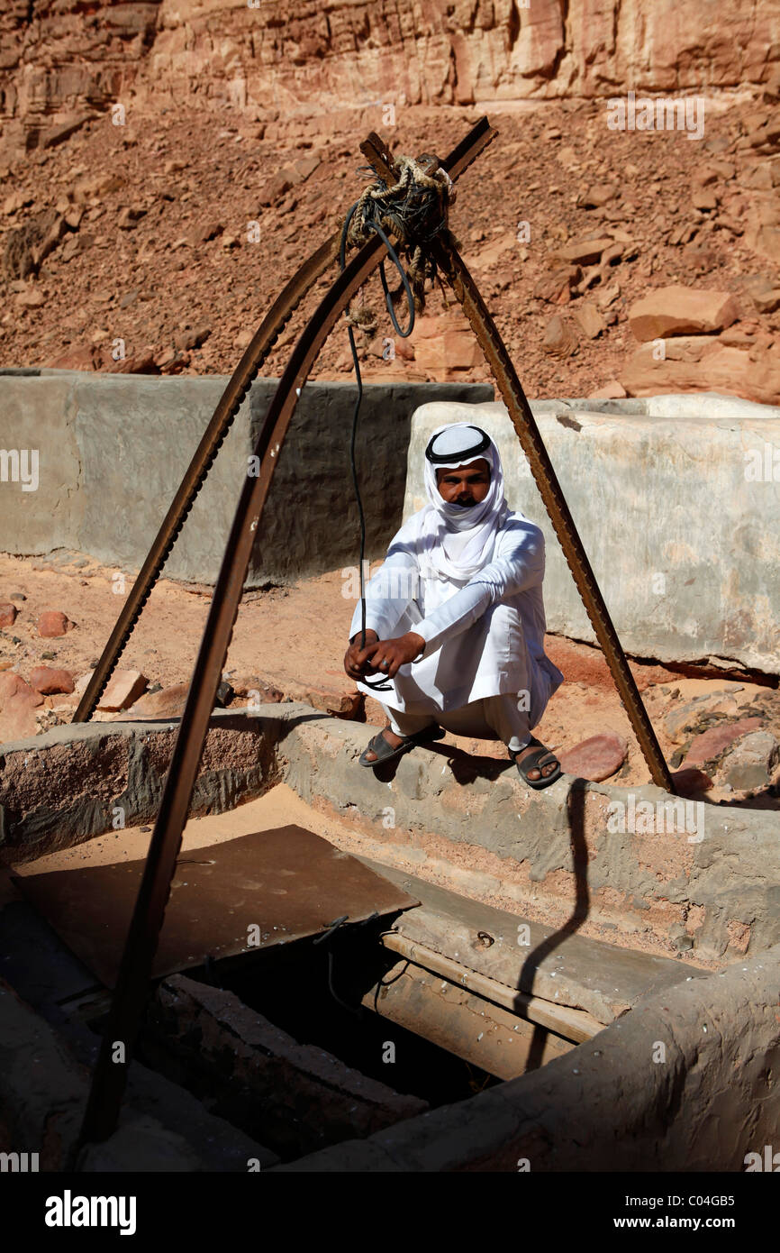 An Arab man squats by a well in the Sinai Desert, Egypt Stock Photo Alamy
