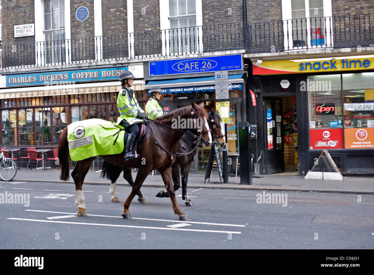 Female police officers riding in Wellington Street, Covent Garden, London Stock Photo