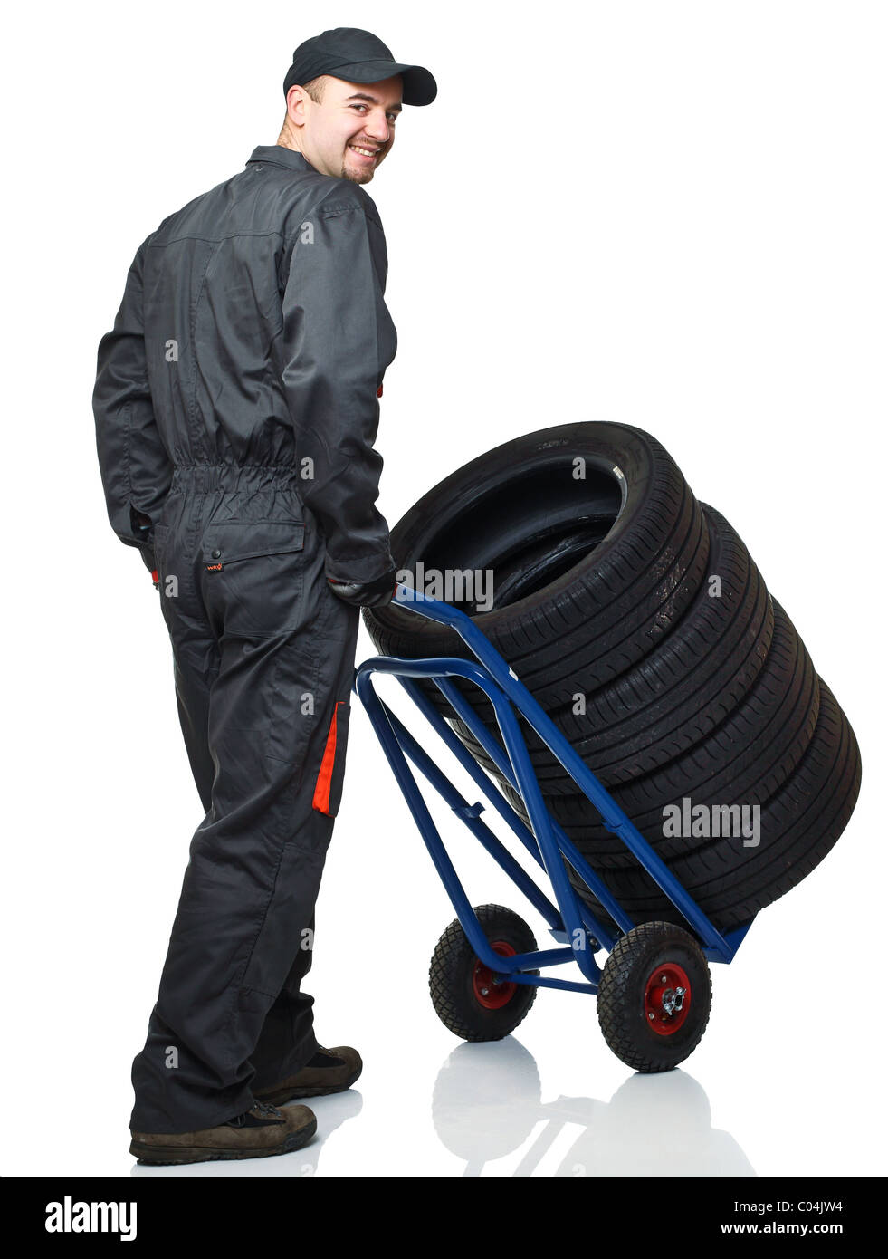 manual worker with handtruck and tires on white background Stock Photo