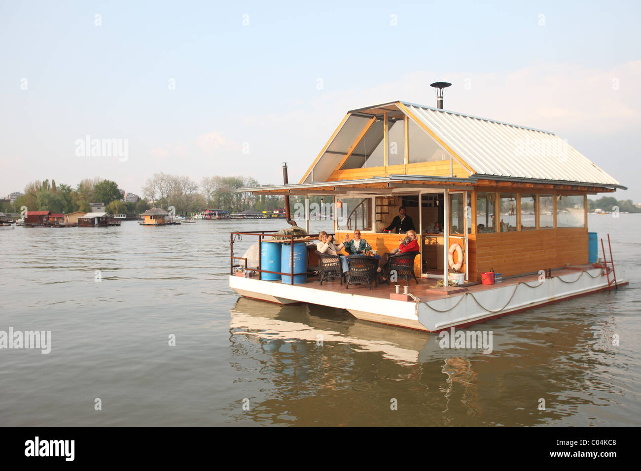 BELGRADE, SERBIA - APRIL 17 : Belgradians enjoying a weekend lunch on their private house boat on April 17, 2010. Houseboats Stock Photo