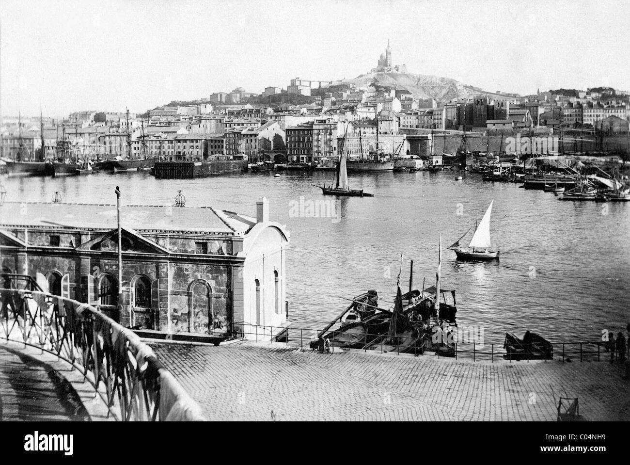 Townscape, Cityscape or View of the Old Port with Yachts or Sailing Boats, Marseille or Marseilles, and the Basilica of Notre-Dame de la Garde France c1890 Stock Photo