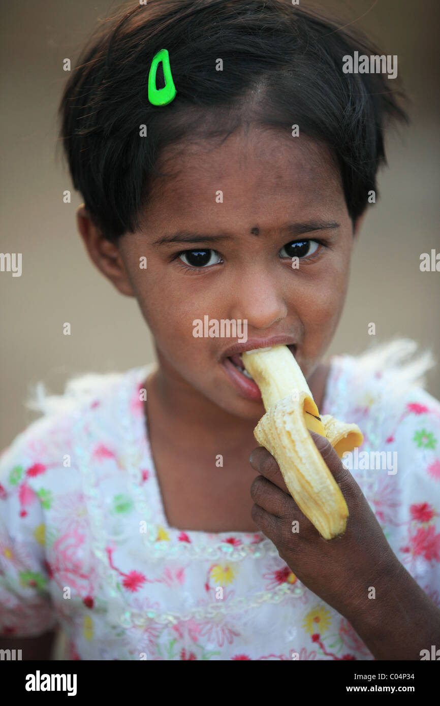 girl eating a banana Andhra Pradesh South India Stock Photo - Alamy