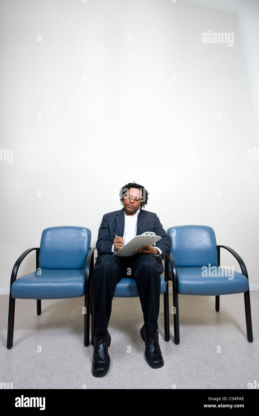 Man waiting alone in waiting room at doctors office Stock Photo Alamy