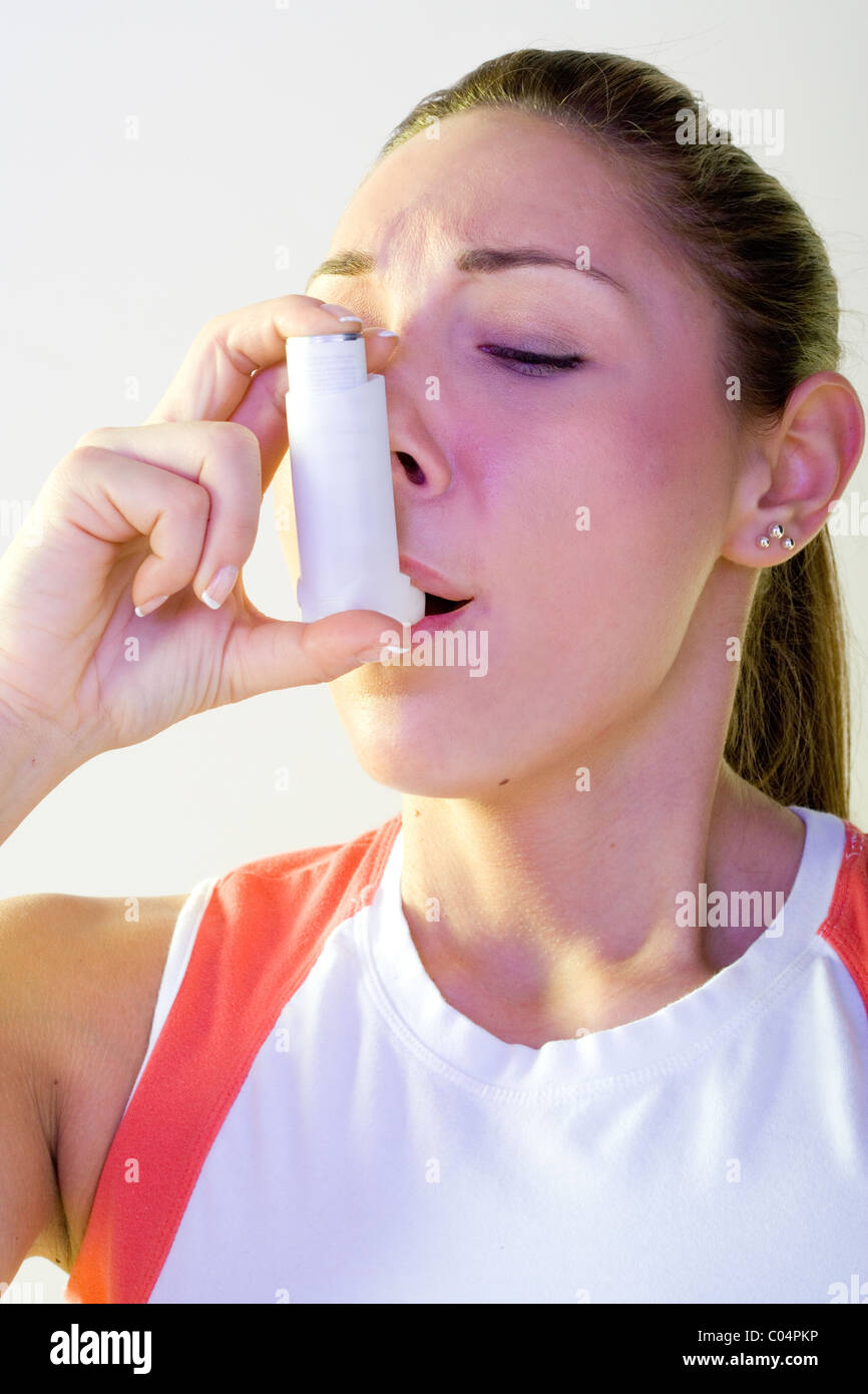 Closeup of woman using inhaler, exercise induced asthma Stock Photo Alamy
