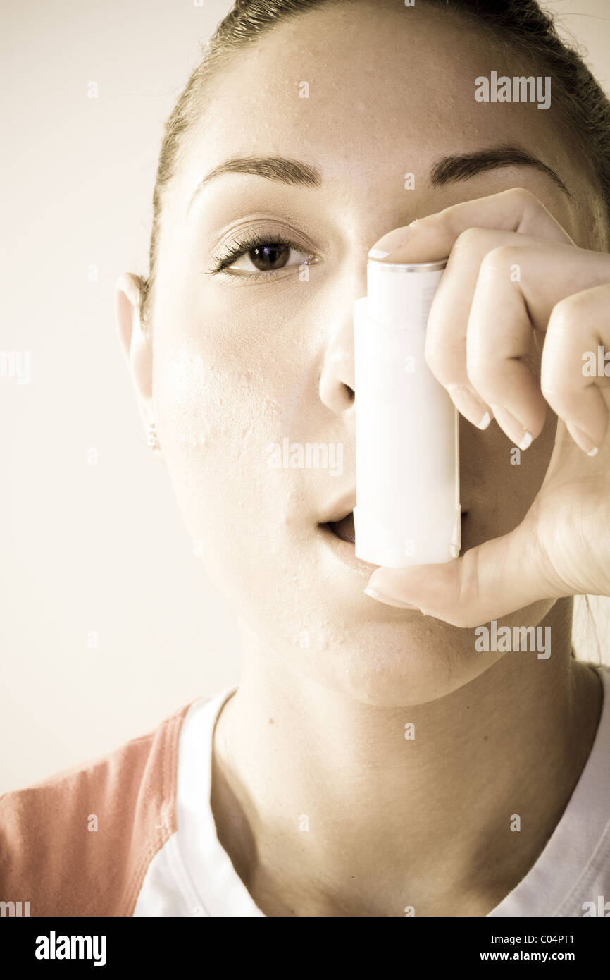 Closeup of woman using inhaler, exercise induced asthma Stock Photo