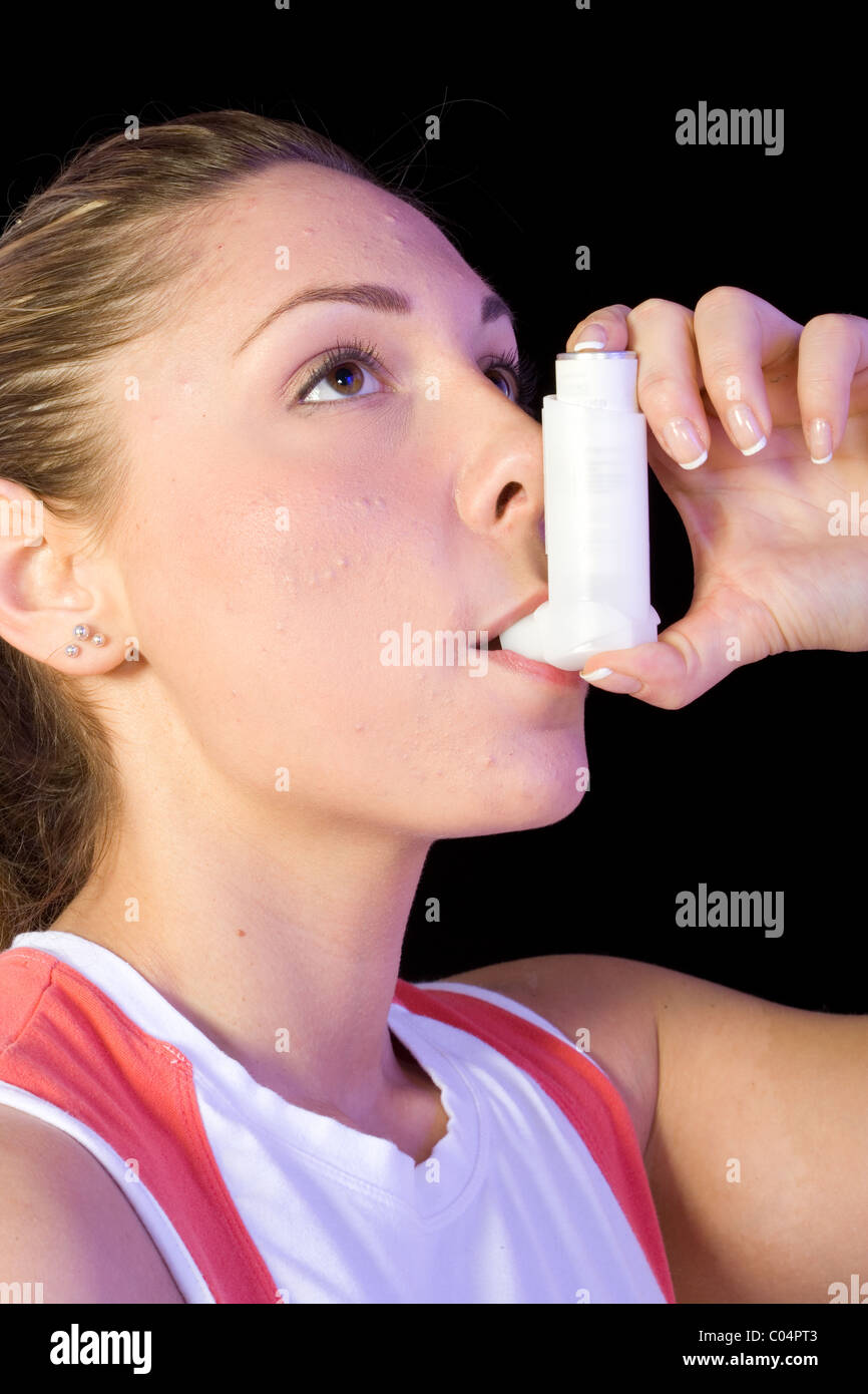 Closeup of woman using inhaler, exercise induced asthma Stock Photo
