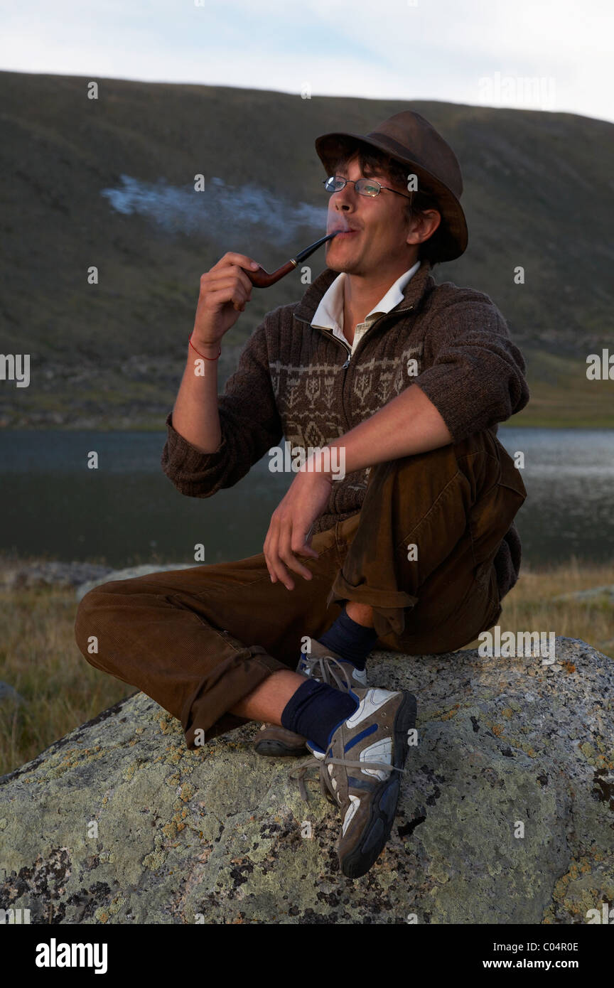 man in hat is smoking tobacco-pipe Stock Photo - Alamy