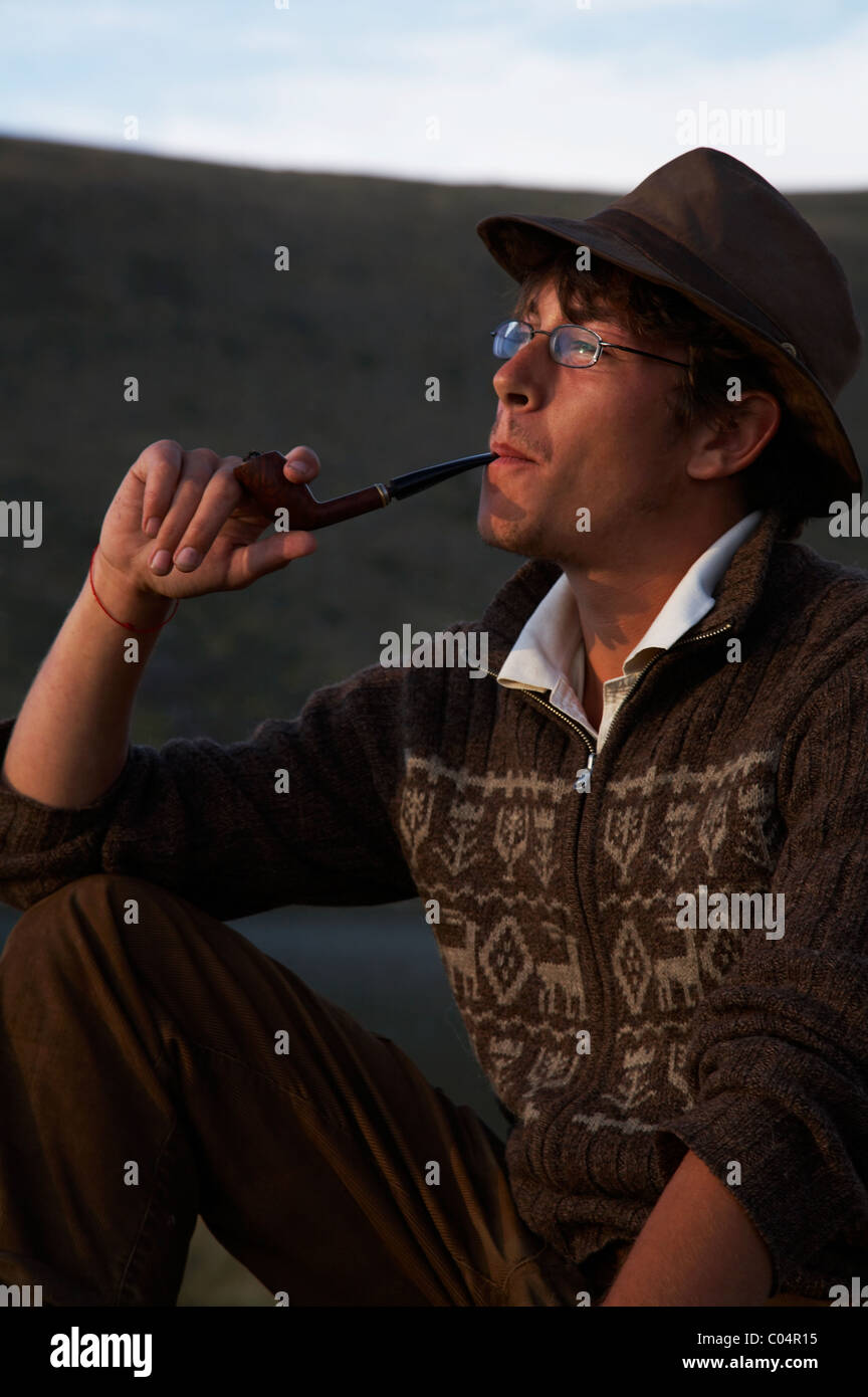 man in hat is smoking tobacco-pipe Stock Photo - Alamy