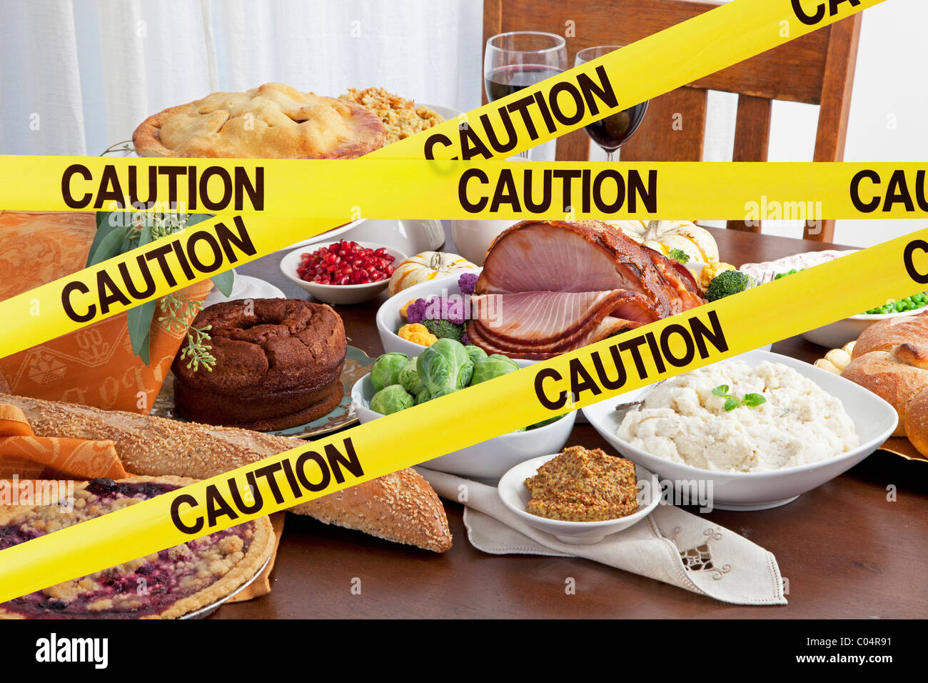 Caution tape blocks a feast  of food and big holiday meal Stock Photo