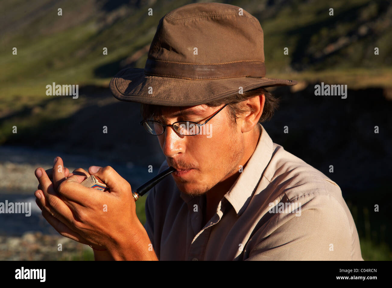 man in hat is smoking tobacco-pipe Stock Photo - Alamy