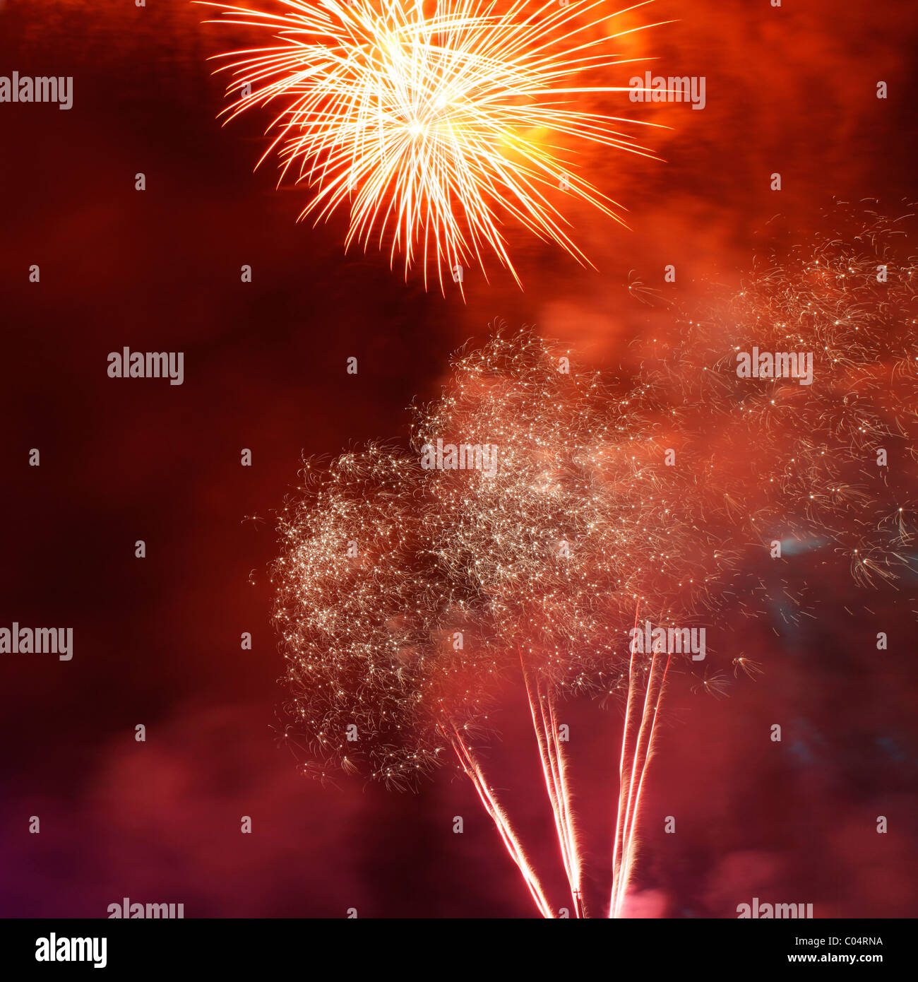 Fireworks burst and light up a night sky. Stock Photo