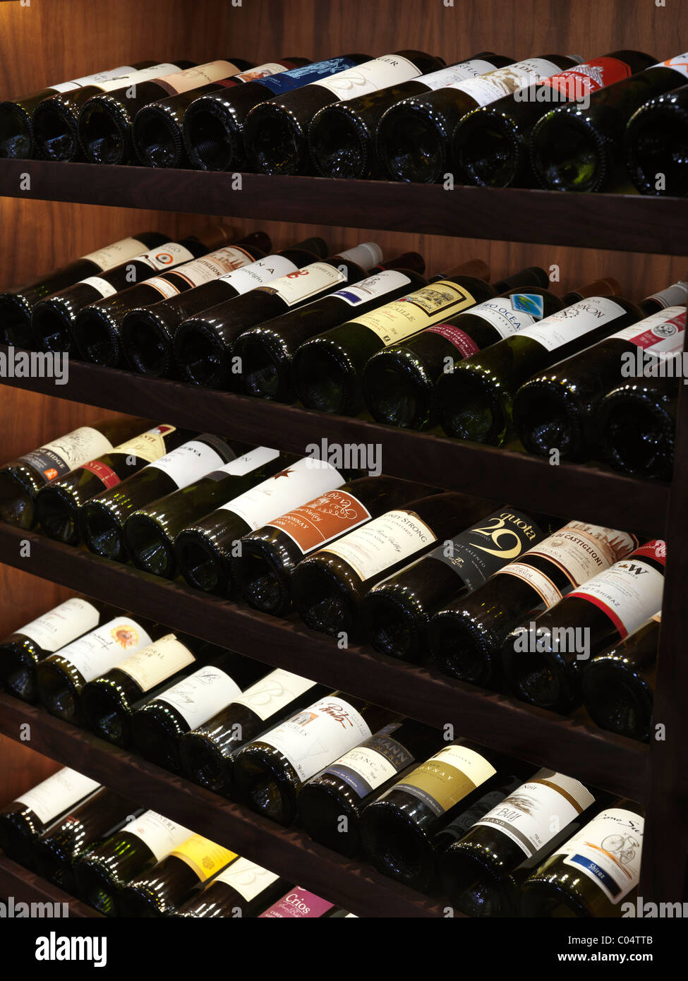 Wine bottles on wine rack shelves Stock Photo