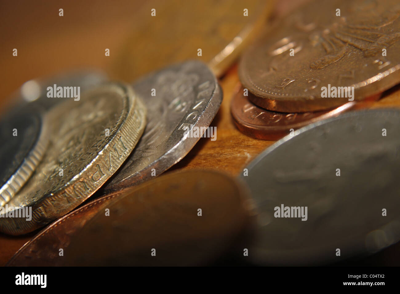 coins on wooden table Stock Photo