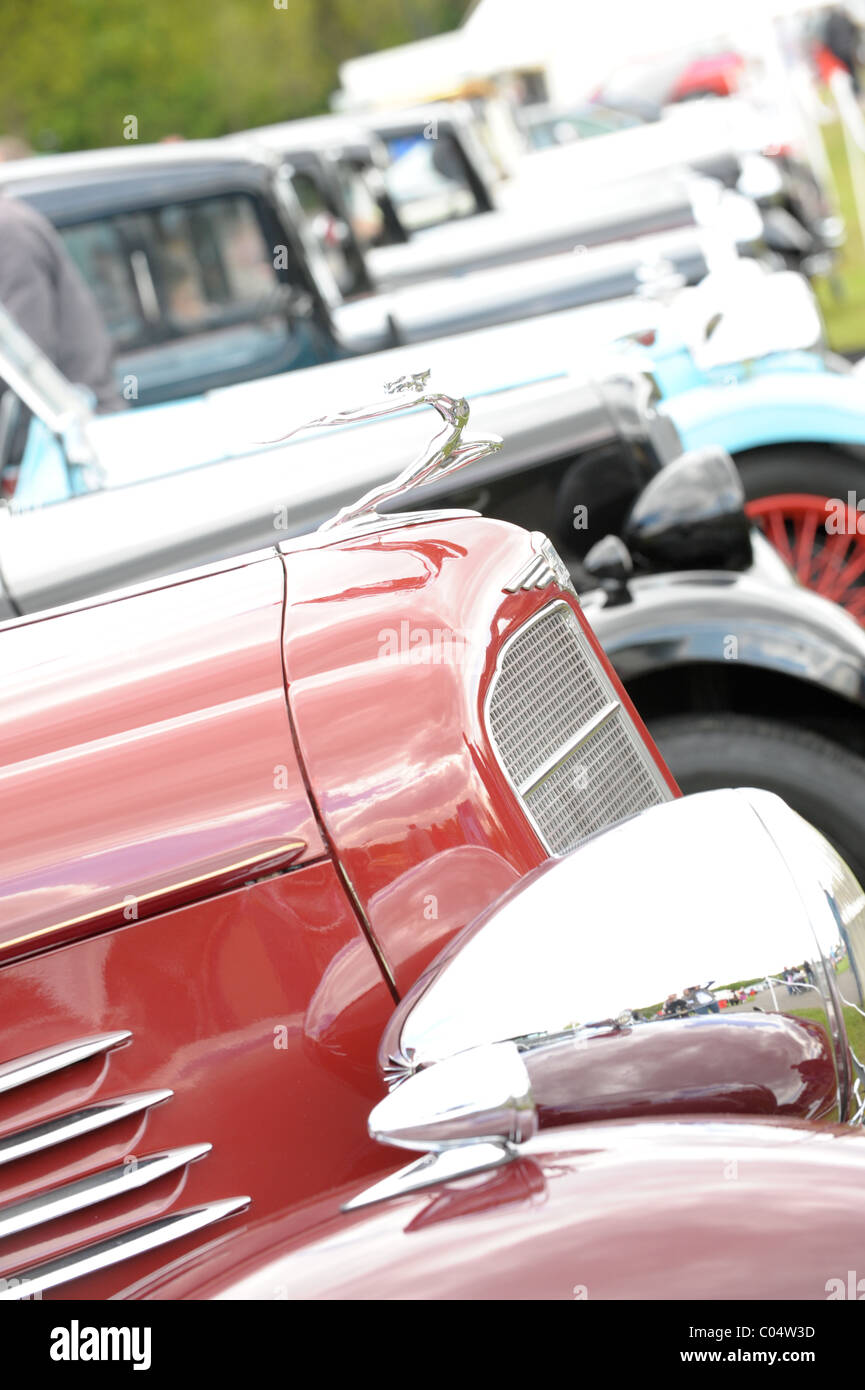 Vintage and classic cars on show at a summer rally including Austin A35, Black police rover, Triumph, all in pristine condition Stock Photo