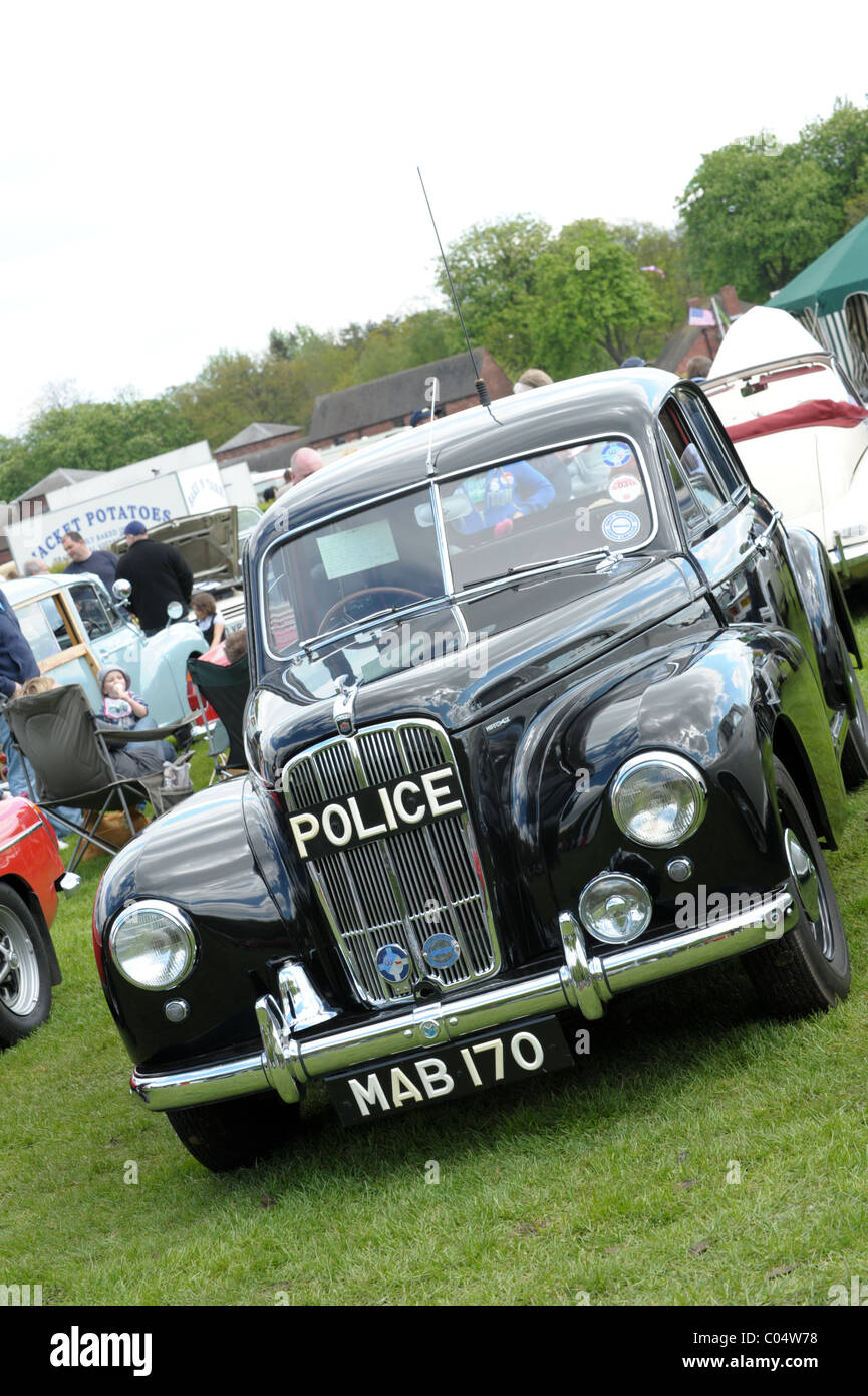 Vintage and classic cars on show at a summer rally including Austin A35, Black police rover, Triumph, all in pristine condition Stock Photo