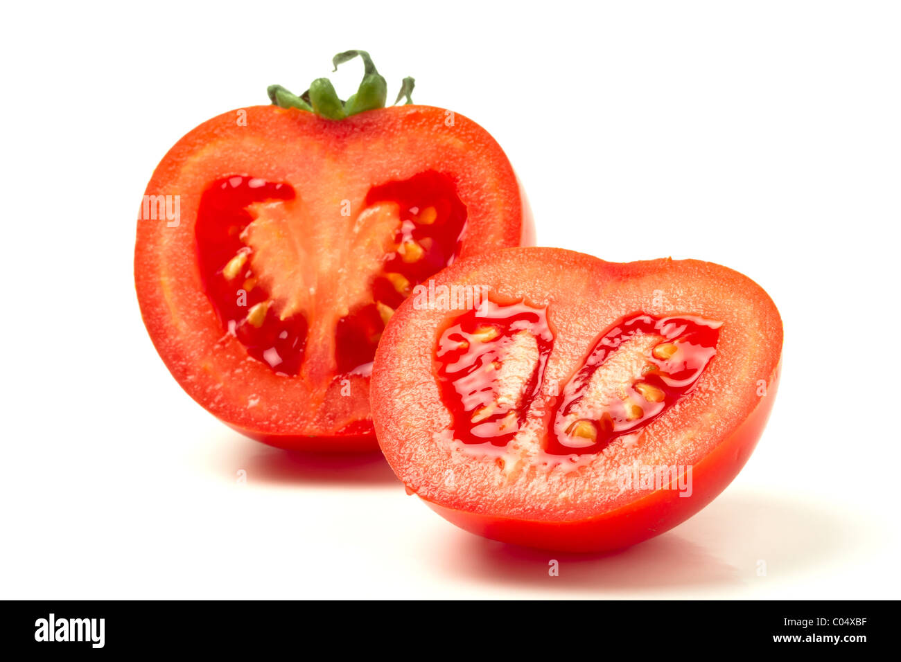 Sliced salad tomato from low perspective isolated on white. Stock Photo