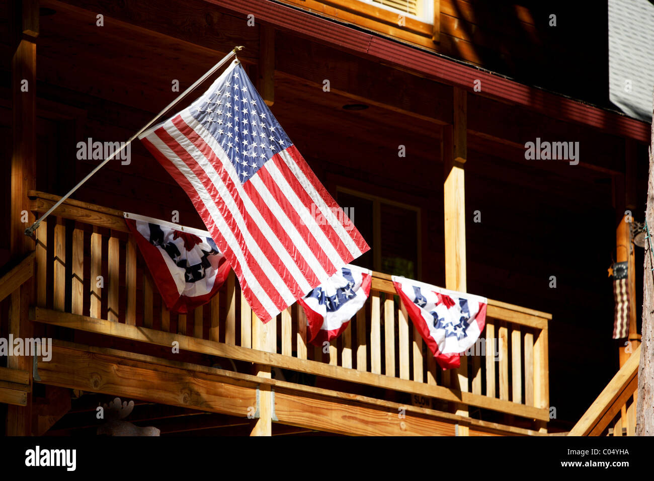 American flags fly in the wind as decoration at a summer home Stock Photo